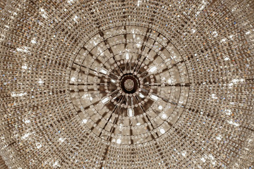 Close-up photo of vintage crystal chandelier in the restaurant.