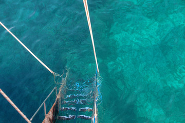ship ladder in transparent sea water