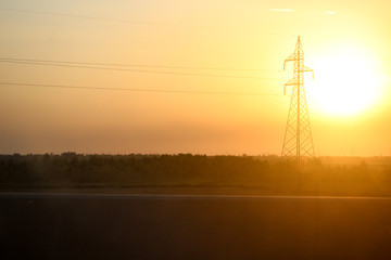 Sunset with electricity pole from the road view