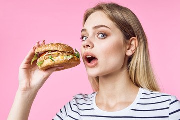 young woman eating hamburger