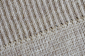 An example of combining different styles of knitting on one fragment of a woolen Scandinavian sweater. Diagonal pattern. Warm clothes for winter cold. Texture for design or research