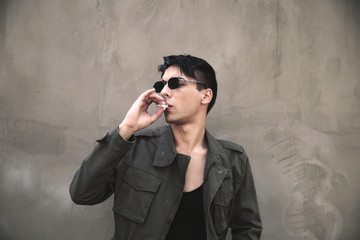 Young man smoking cigarette outdoors
