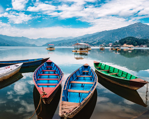 Colourful wooden tourist boats in Pokhara lake in Nepal.