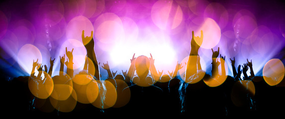 Musical event with people silhouettes clapping a live stage