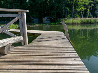 Fototapeta na wymiar beautiful summer view of Valdis lake shore, wooden footbridge by the lake, Latvia
