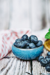 Myrtilles du jardin et menthe fraiche dans un pot en céramique bleu