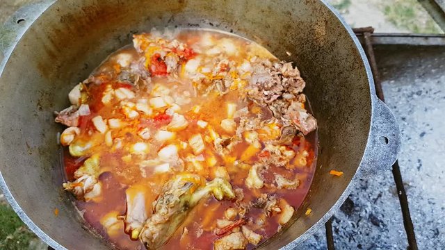 Bograch. Soup with paprika, meat, bean, vegetable, dumpling. Traditional Hungarian Goulash in cauldron. Meal cooked outdoors on an open fire. Delicious and healthy food popular in Central Europe