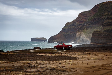 The car near the ocean, rocky coast.