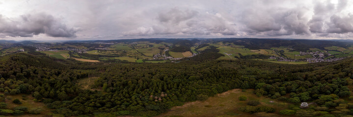 360 degrees panorama from above the pilgrimage catholic mountain of Wilzenberg in the Sauerland region in Germany with the Graftschaft and Schmallenberg villages and agrarian surrounding