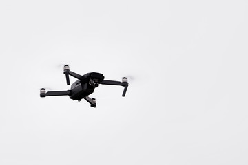 Flying copter. The drone quadcopter on white background, close-up