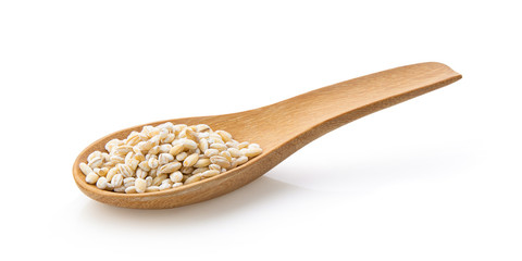 pile of pearl barley in wood spoon  isolated on white background