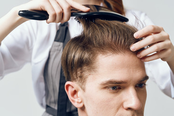 Fototapeta premium hairdresser cutting hair