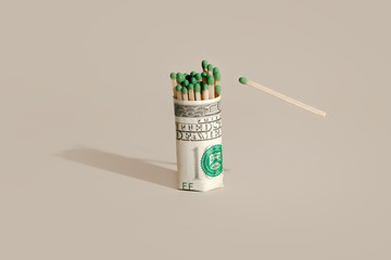 Matchstick and dollar bill on a green background. Fire insurance concept	