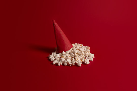 Popcorn in an ice cream cone on a red background. Christmas concept, top view. Flat layer
