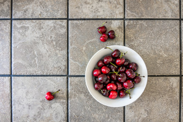 Overhead of bowl of red fresh cherries