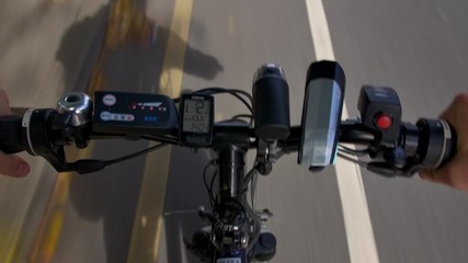 Man riding electric bike in first person view on British road, cycling bicycle 
