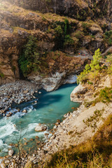 River flows trough rocky valley in Himalaya mountains in Nepal.