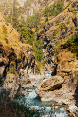 River flows trough rocky valley in Himalaya mountains in Nepal.