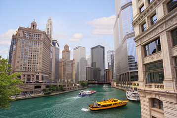 Chicago River with water taxi and boats sailing between the beautiful skyscrapers skyline, Illinois, USA