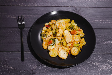 plant-based potato and veggies bake with vegan cheese topping and herbs
