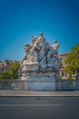 Fototapeta na wymiar Allegorical group of the Ponte Vittorio Emanuel II in Rome, Italy