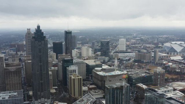 Drone shot above Midtown Atlanta on a cloudy day after a storm. Facing Downtown further past the Bank of America Tower.