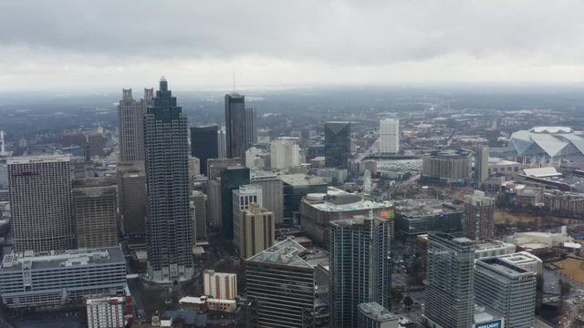 Drone shot above Midtown Atlanta on a cloudy day after a storm. Pushing in towards Downtown.