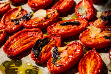 Dried tomatoes with garlic, Basil and salt on parchment paper