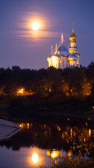 Fototapeta na wymiar St. Sophia Cathedral and bell tower at night, against a full moon.