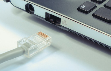 Fototapeta premium Closeup of disconnected internet cable to laptop