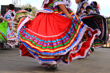 Colorful skirts fly during Mexican dancing - obrazy, fototapety, plakaty