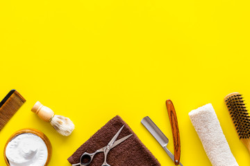 Men's shaving accessories on yellow background top view copy space
