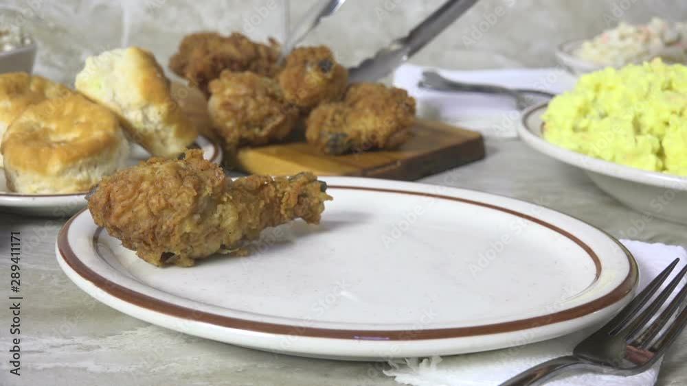 Poster serving fresh fried chicken drumsticks slow motion, closeup