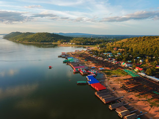 Aerial panoramic view of fishing village on the lake with mountain, Clouds and blue sky background.