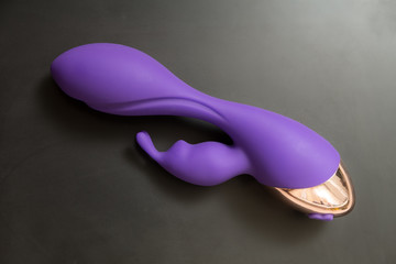purple vibrator on black background