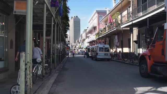 View down a street in the French Quarter to the modern downtown skyline of New Orleans, Lousiana.