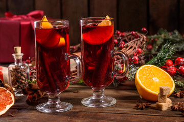 Christmas hot mulled wine with cinnamon cardamom and anise on wooden background