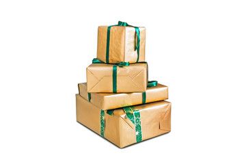 four large boxes wrapped in shiny gold gift paper. Beautiful gifts for Christmas and new year. Holiday gifts. Holiday gift boxes decorated with ribbon isolated on white background.