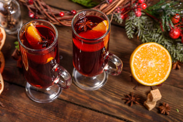 Christmas hot mulled wine with cinnamon cardamom and anise on wooden background