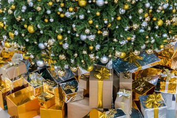 Gift boxes with Christmas tree at the background for surprise Children in New year or Xmas party festival. Christmas party event and Happy new year theme. Decorated property in worm home.