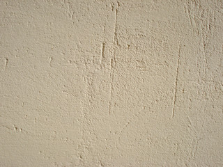 Beige wall texture background. Stucco pattern. Sand dabs plaster. 