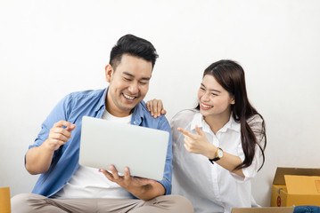 Asian couple with stack of parcel boxes, online business and delivery concept.