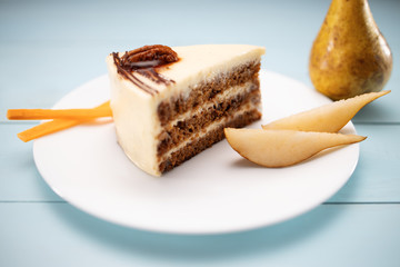 Cake piece with chocolate, milk cream, carrots and nuts isolated