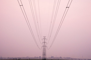 High Voltage Power Lines Pole on sunset scene background