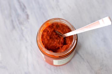 Ajvar in a jar, a delicious roasted red pepper and eggplant dish/ Ajvar - traditional Macedonian Serbian dish made from red bell peppers, eggplant and garlic, Lutenitza, popular in Balkans. Homemade
