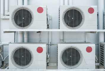 Group of air compressors outside the industry building wall. Air compressors installed in the...