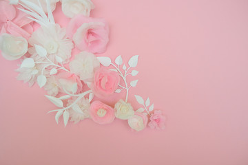 White paper flowers on pink background.