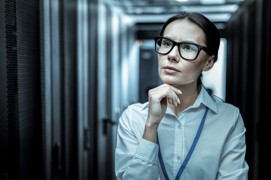 Pleasant-looking woman in eyeglasses thinking over the case