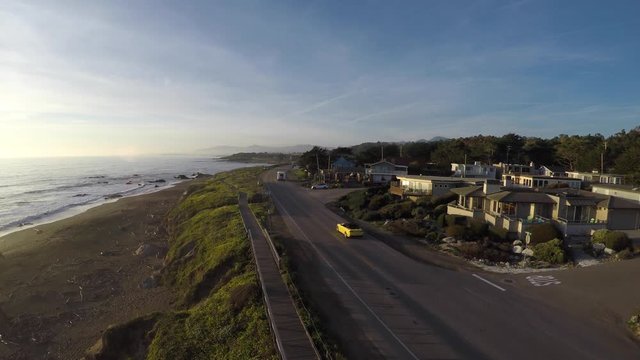 Cinematic aerial video of car driving along Moonstone Beach, California at sunset