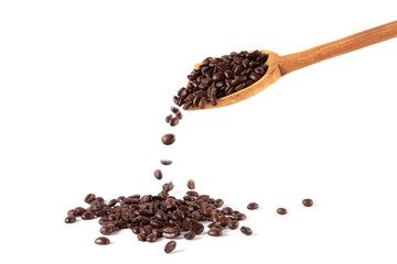 Coffee bean falling from spoon on white background